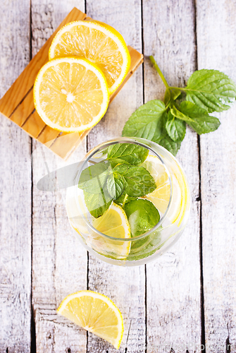 Image of fresh lemon and mint for cocktail on a table