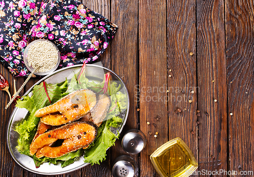 Image of roast salmon steaks with fresh salad on plate