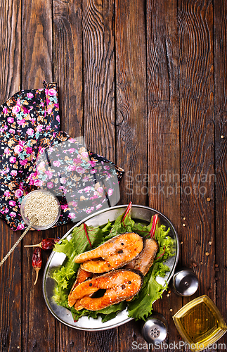 Image of roast salmon steaks with fresh salad on plate