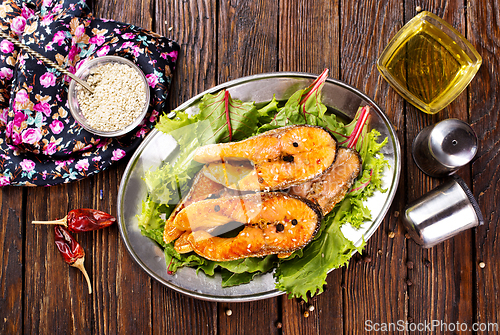 Image of roast salmon steaks with fresh salad on plate