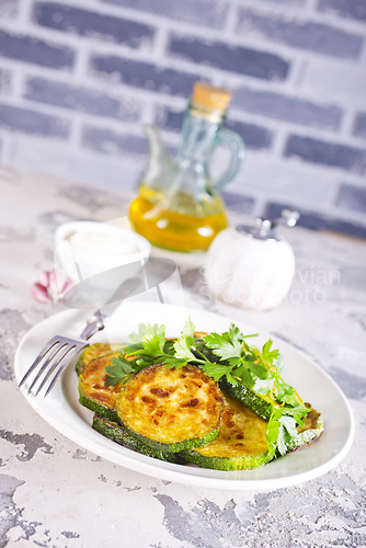 Image of Heap of fried green zucchini with garlic
