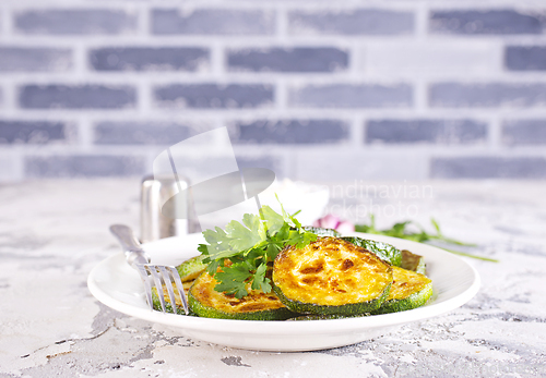 Image of Heap of fried green zucchini with garlic