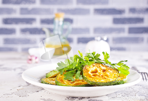 Image of Heap of fried green zucchini with garlic