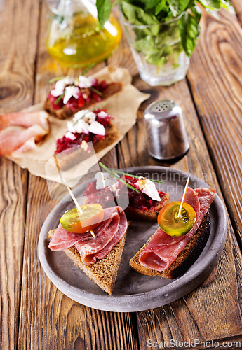 Image of Traditional Spanish Jamon Serrano ham, Prosciutto Crudo, Parma ham, Italian antipasto