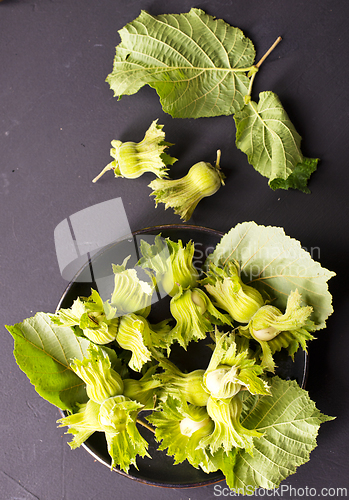 Image of hazelnuts on black table