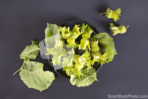 Image of hazelnuts on black table
