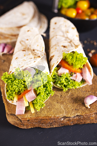 Image of Fresh tortilla wraps with ham cheese and vegetables