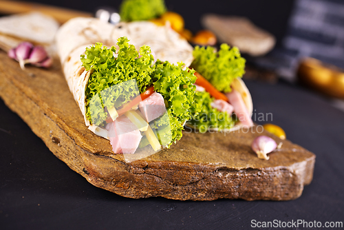 Image of Fresh tortilla wraps with ham cheese and vegetables