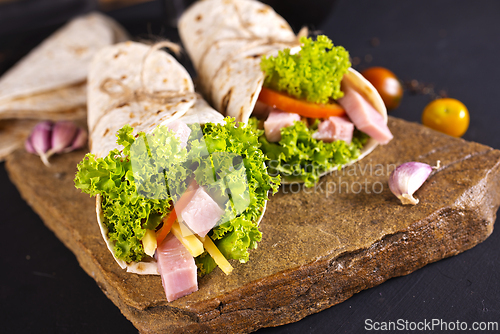 Image of Fresh tortilla wraps with ham cheese and vegetables