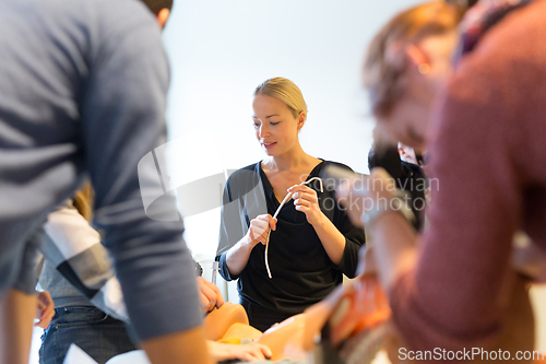 Image of Medical doctor specialist expert displaying method of patient intubation on hands on medical education training and workshop. Participants learning new medical procedures and techniques.
