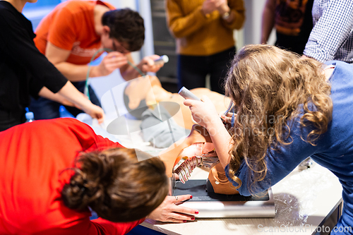 Image of Medical doctor specialist expert displaying method of patient intubation on hands on medical education training and workshop. Participants learning new medical procedures and techniques.