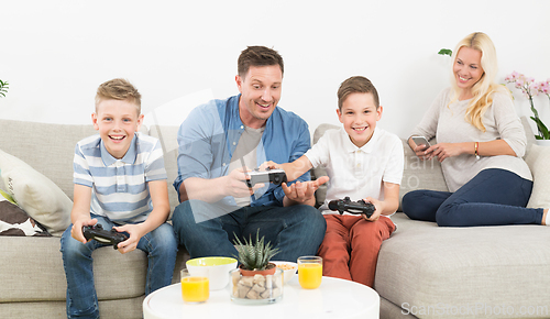 Image of Happy young family playing videogame On TV.