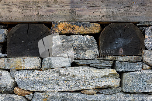 Image of Stone and log construction detail showcasing craftsmanship in mo