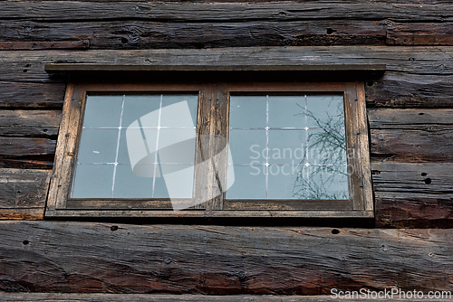 Image of Rustic wooden cabin window showcasing craftsmanship and natural 