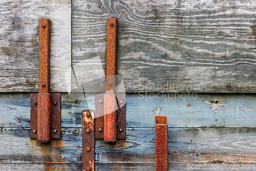 Image of Rusty hardware on aged wooden structure shows weathered charm ne
