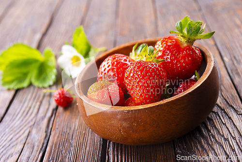 Image of Close up of ripe organic strawberry food wooden table