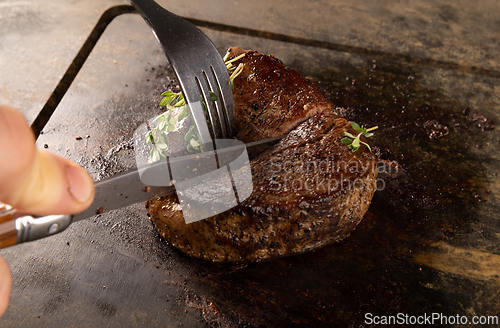 Image of Chef cutting grilled steak