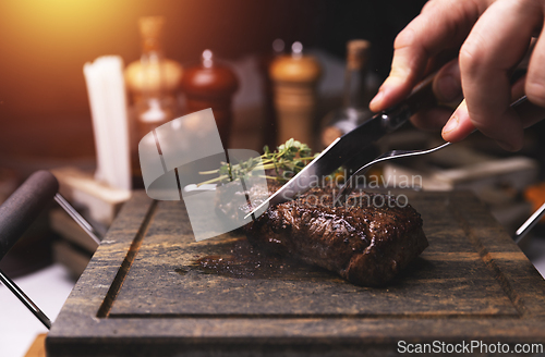 Image of Chef cutting grilled steak