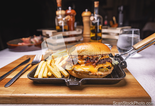 Image of Tasty hamburger with melted cheese