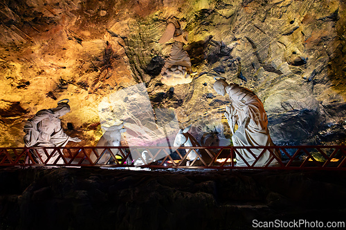 Image of Nativity scene against the illuminated rock wall of the Salt Cathedral of Zipaquira, Colombia.