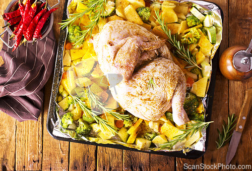 Image of Uncooked chicken with parsley and potatoes