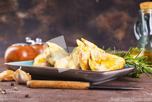 Image of raw chicken wings on stone background