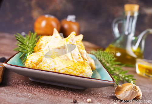 Image of raw chicken wings on stone background