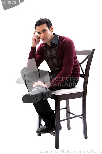 Image of Handsome guy sitting on chair