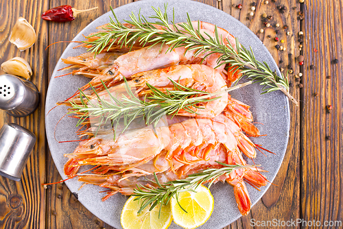 Image of Plate with tasty boiled shrimps, rosemary and lime