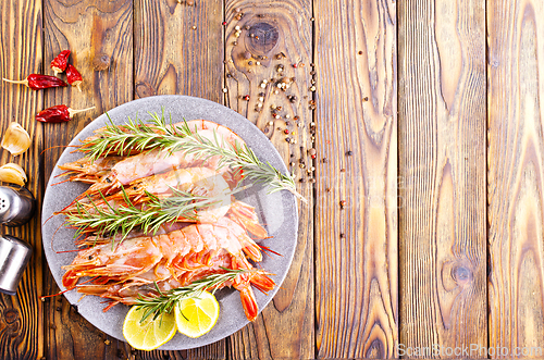 Image of Plate with tasty boiled shrimps, rosemary and lime