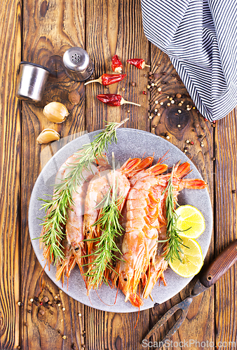 Image of Plate with tasty boiled shrimps, rosemary and lime