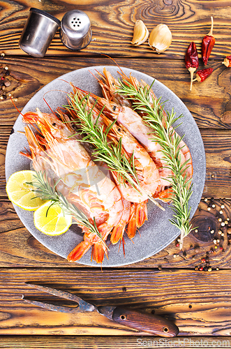 Image of Plate with tasty boiled shrimps, rosemary and lime