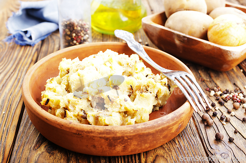 Image of Simple food mashed potatoes with caramelized onions close-up on a plate on the table.