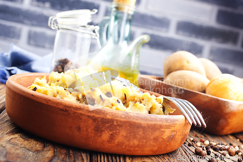 Image of Simple food mashed potatoes with caramelized onions close-up on a plate on the table.