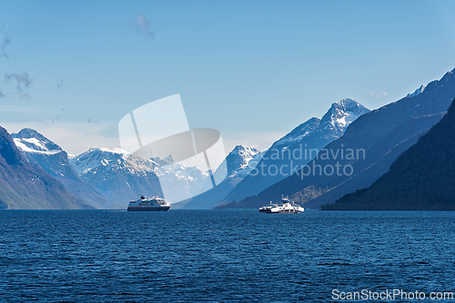 Image of Breathtaking view of fjords with boats sailing in tranquil water