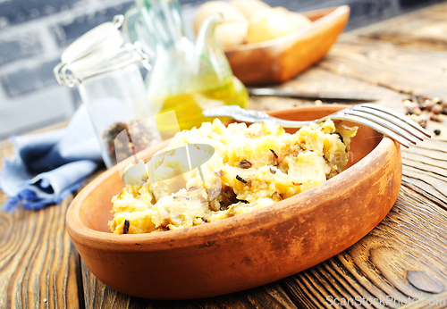 Image of Simple food mashed potatoes with caramelized onions close-up on a plate on the table.
