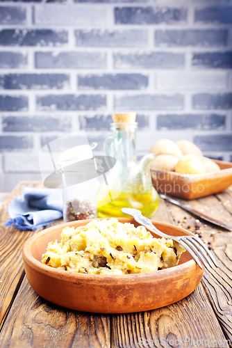 Image of Simple food mashed potatoes with caramelized onions close-up on a plate on the table.