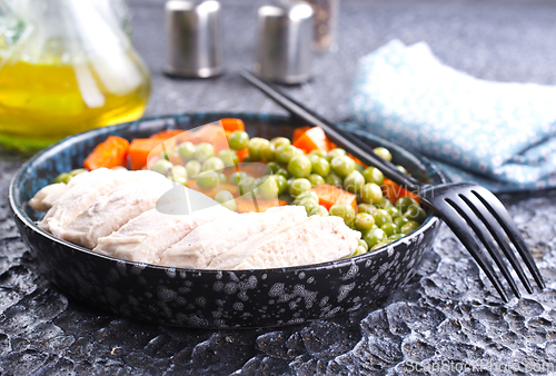 Image of Savory vegetable stew with chicken fillet on plate on a table
