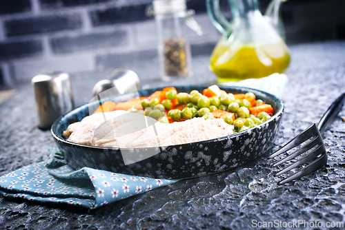 Image of Savory vegetable stew with chicken fillet on plate on a table