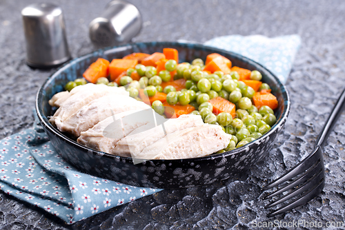 Image of Savory vegetable stew with chicken fillet on plate on a table