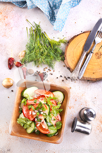 Image of Vegetable salad in wooden bowl