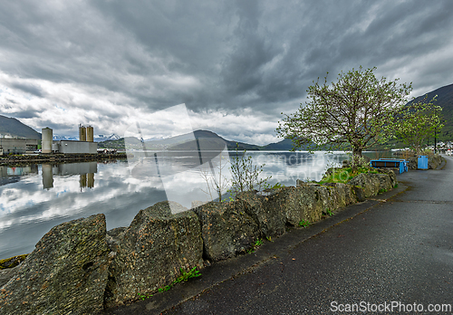 Image of Tranquil waterfront view with overcast skies and reflections in 