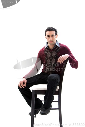 Image of Handsome guy sitting on chair