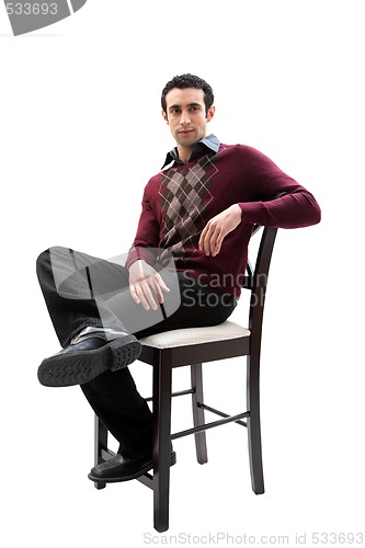 Image of Handsome guy sitting on chair