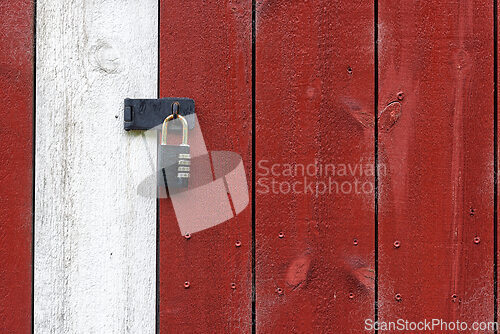 Image of Rustic wooden door with red and white paint featuring a sturdy p