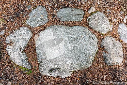 Image of Unusual stone formation resembling a paw print found in a gravel