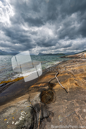 Image of Dramatic coastal landscape with rocky shore and cloudy skies nea