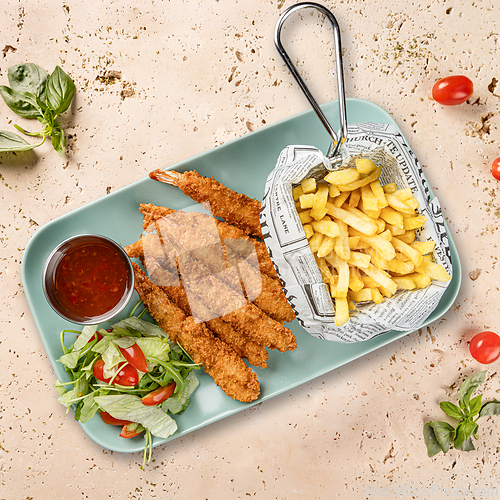Image of Breaded shrimps served with french fries