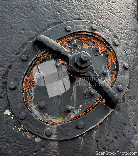 Image of Rustic ship hatch cover with handle details showcasing wear and 