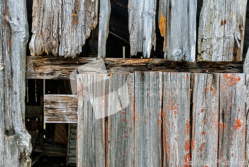 Image of Weathered wooden planks showcase textures and decay in an abando